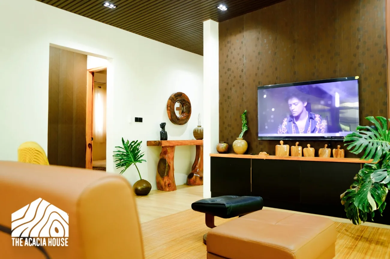 Lounge with a smart TV, leather seating and carved wooden decor